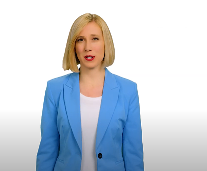 Woman in a blue blazer standing confidently on a white background, delivering a relationship message.